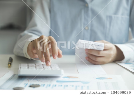Accountant using calculator for calculate finance report in office Accountant using calculator for calculate finance report in office 104699089