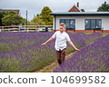 Little school boy enjoying time in lavender field. Calm and peace. Beautiful flowers 104699582