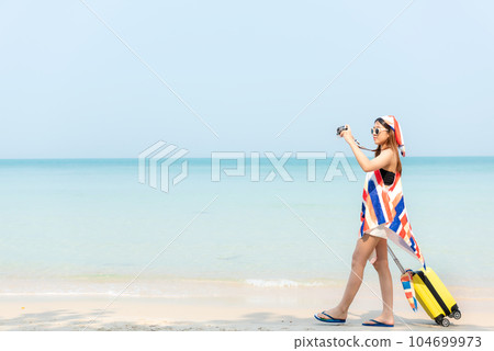 Happy traveler and tourism women travel summer walking on beach Happy traveler and tourism women travel summer walking on beach 104699973