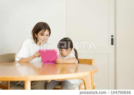 Parent and child seeing tablet 104700698