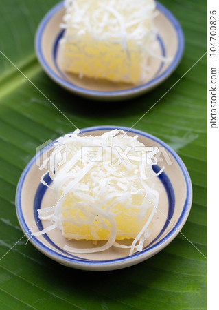 Steamed tapioca cake or cassava cake with grated coconut 104700826