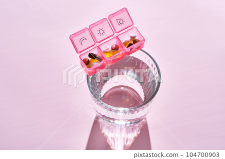 Bright pill box with different pills and vitamins. Bright pill box with different pills and vitamins. 104700903
