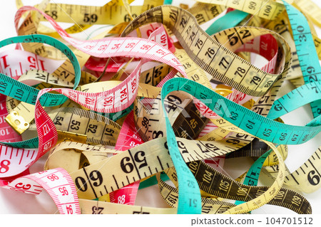 Measuring tapes on white background. 104701512