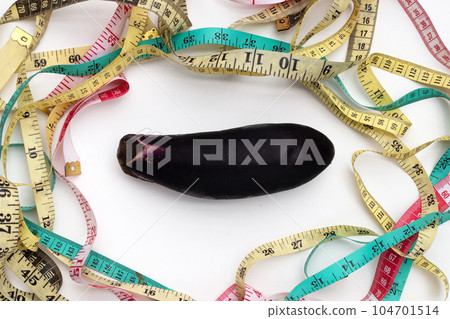 Eggplant with measuring tape on white background. 104701514