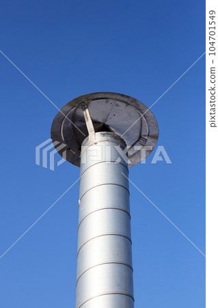 Metal chimney pipe on the roof of house Metal chimney pipe on the roof of house 104701549