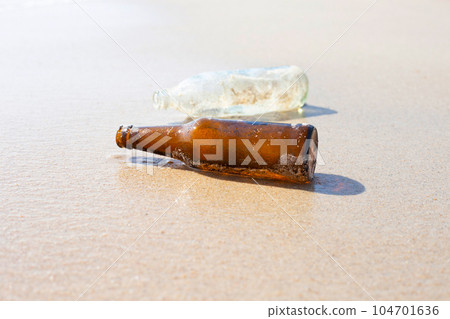 Glass bottles on the beach 104701636