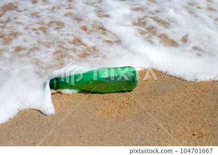 Green plastic bottle on the beach Green plastic bottle on the beach 104701667