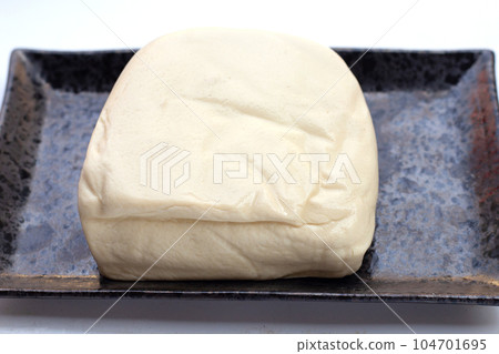 White tofu in black plate on white background White tofu in black plate on white background 104701695