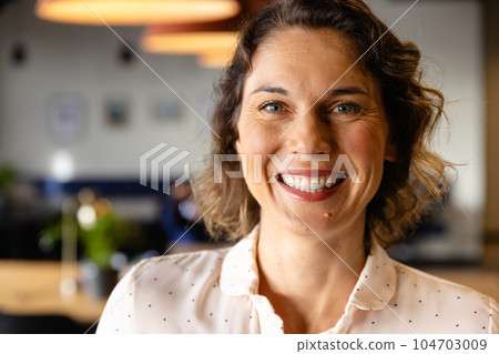 Portrait of happy caucasian casual businesswoman in office Portrait of happy caucasian casual businesswoman in office 104703009