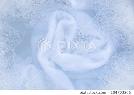 Top view of towel soak in powder detergent water dissolution. Laundry concept 104703866