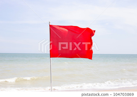 A red flag. Warning sign on the beach A red flag. Warning sign on the beach 104703869