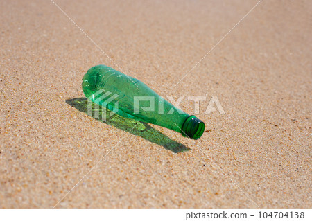 Green plastic bottle on the beach Green plastic bottle on the beach 104704138