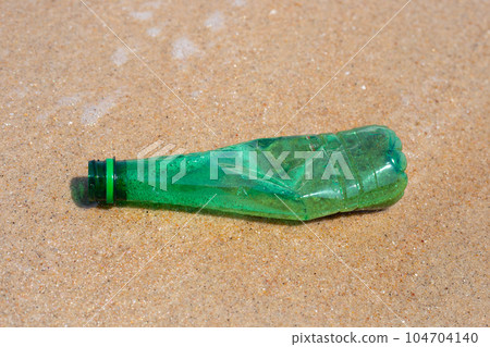 Green plastic bottle on the beach Green plastic bottle on the beach 104704140