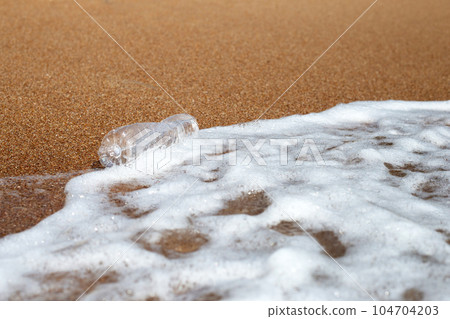 Plastic bottle on the beach Plastic bottle on the beach 104704203