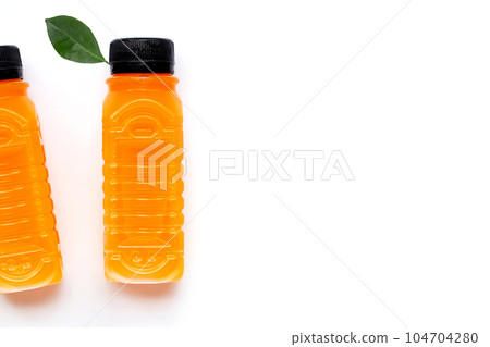 Orange juice in plastic bottles on white 104704280