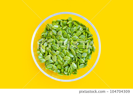 Seeds of leucaena leucocephala on yellow background. Seeds of leucaena leucocephala on yellow background. 104704309