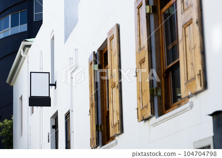Blank sign fixed to building wall with copy space 104704798