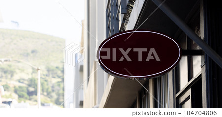 Blank oval sign fixed to building wall with copy space Blank oval sign fixed to building wall with copy space 104704806