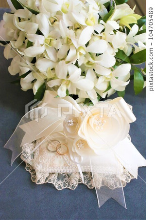 White bouquet, ring pillow and marriage ring 104705489