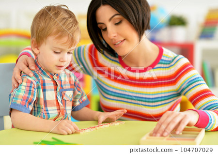 Young mother and cute little son playing Young mother and cute little son playing 104707029