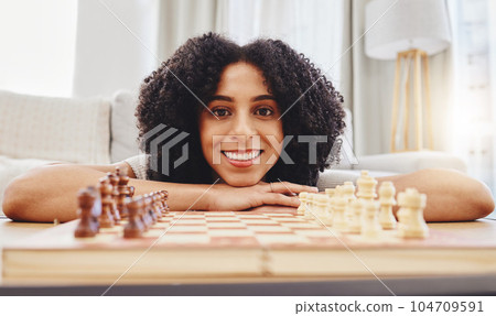 Chess, game and portrait of woman with board for strategy, thinking and challenge at home. Competition, winning and female person with chessboard in living room ready for playing and problem solving Chess, game and portrait of woman with board for strategy, thinking and challenge at home. Competition, winning and female person with chessboard in living room ready for playing and problem solving 104709591
