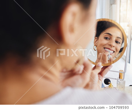 Woman, lipstick and mirror at home with a smile from makeup and cosmetics. Young female person, face and morning routine feeling happy with beauty and skincare in house with wellness and cosmetology Woman, lipstick and mirror at home with a smile from makeup and cosmetics. Young female person, face and morning routine feeling happy with beauty and skincare in house with wellness and cosmetology 104709593