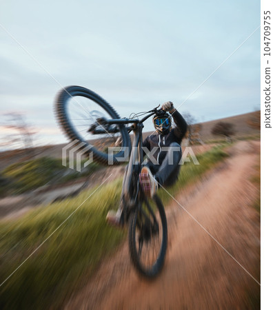Cycling, danger and a man in nature with a motorbike for travel, bicycle speed and action on the dirt road. Sport, summer and biker with a motorcycle in the countryside for vacation or power 104709755