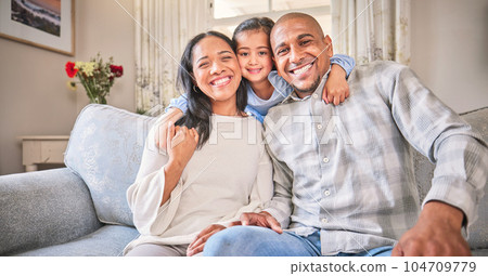 Portrait, family and smile on sofa in home living room, bonding and having fun. Face, parents and happy child, mother and father with love, relax on couch and enjoying quality time together in house. 104709779