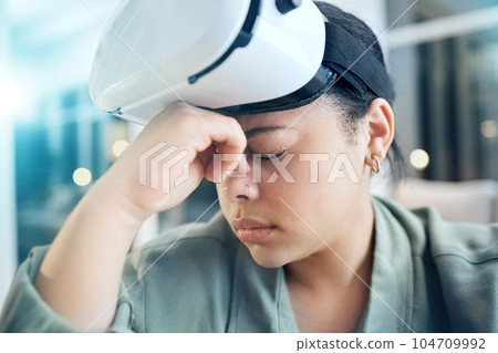 Woman in virtual reality headset with headache, pain and dizzy from gaming or working in future technology. Stress, exhausted eyes and tired girl with vr glasses, fatigue and vision problem in office 104709992