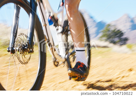 Closeup, outdoor and biker with fitness, speed and training with performance, challenge and progress. Zoom, male person and cyclist with workout goal, nature or travel with sports, fast and target 104710022