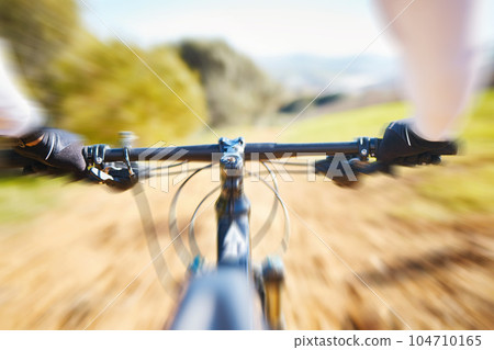 Fitness, cycling and person pov on bike in nature for extreme sports, race or training with motion blur. Bicycle, exercise and cyclist riding on dirt road with energy, adrenaline or speed challenge Fitness, cycling and person pov on bike in nature for extreme sports, race or training with motion blur. Bicycle, exercise and cyclist riding on dirt road with energy, adrenaline or speed challenge 104710165