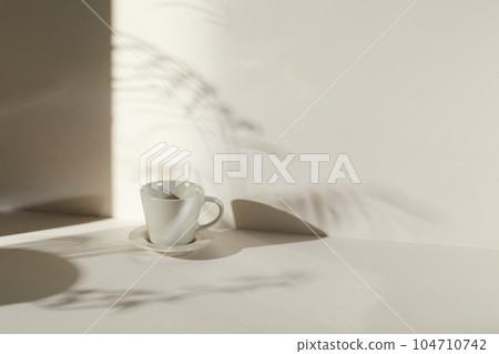 A room with various objects such as warm sunlight, shadows of grass leaves, a vase on a table, and cups A room with various objects such as warm sunlight, shadows of grass leaves, a vase on a table, and cups 104710742