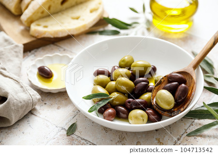 Olives, ciabatta and olive oil in a bottle Olives, ciabatta and olive oil in a bottle 104713542
