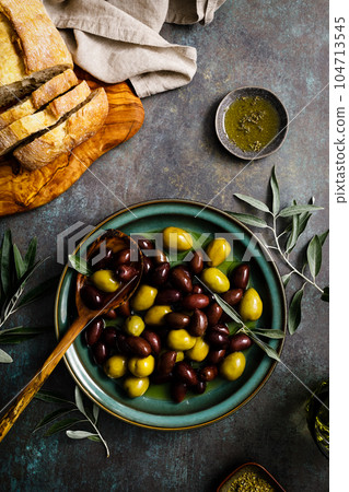 Olives and olive oil, top view Olives and olive oil, top view 104713545