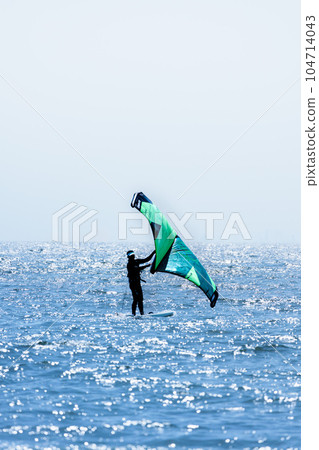 Windsurfing through the water with a refreshing breeze 104714043