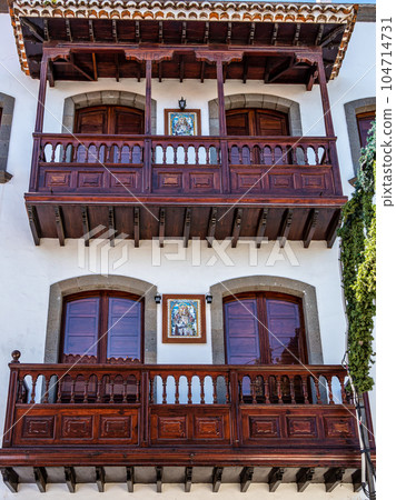 Teror at Gran Canaria, Spain. A beautiful traditional town with colorful houses Teror at Gran Canaria, Spain. A beautiful traditional town with colorful houses 104714731