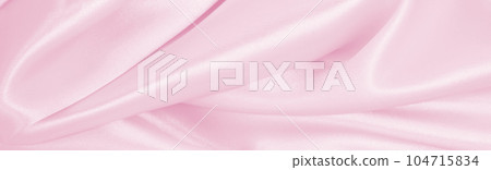 Smooth elegant pink silk or satin texture as wedding background. Luxurious background design Smooth elegant pink silk or satin texture as wedding background. Luxurious background design 104715834