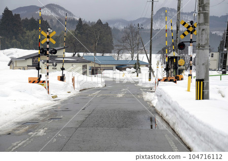 Winter railroad crossing 104716112