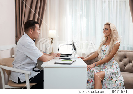 woman talking with doctor about face aesthetic treatment 104716713