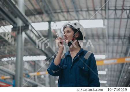 smart woman worker radio control operation team worker in lage warehouse industry factory happy confident. 104716959