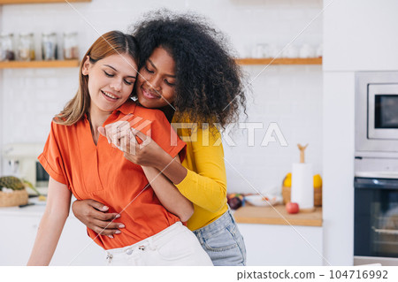 women LGBT lover couple dance embrace romantic happy at home. homosexual woman multiracial black and white girl together. women LGBT lover couple dance embrace romantic happy at home. homosexual woman multiracial black and white girl together. 104716992