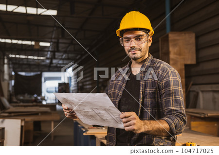 portrait hispanic indian male wood worker happy smile, construction builder man with floorplan designer. portrait hispanic indian male wood worker happy smile, construction builder man with floorplan designer. 104717025