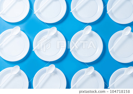 Disposable waste plastic on blue background Disposable waste plastic on blue background 104718158