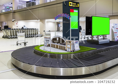 Empty carousel with empty screens at Don Mueang International Airport (DMK)'s Baggage Claim Hall in Terminal 2 for domestic flights. Empty carousel with empty screens at Don Mueang International Airport (DMK)'s Baggage Claim Hall in Terminal 2 for domestic flights. 104719232