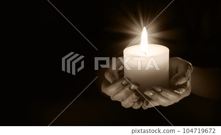 Girls hands hold the candle 104719672