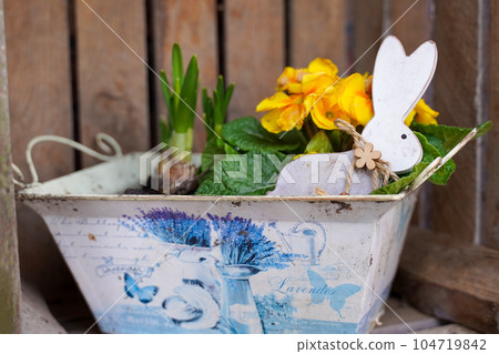 Spring pot with flowers and bunny. Spring garden decor. Spring pot with flowers and bunny. Spring garden decor. 104719842