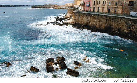 Ortigia Siracusa Island with waves of sea on the rocks Ortigia Siracusa Island with waves of sea on the rocks 104721186