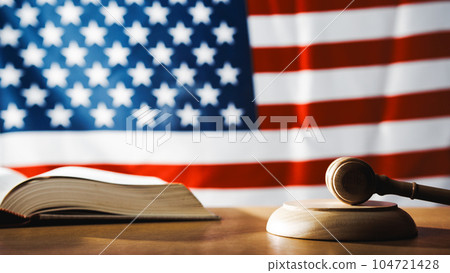 U.S. Supreme Court with gavel on a book and U.S. flag U.S. Supreme Court with gavel on a book and U.S. flag 104721428