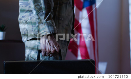 Soldier carries a work suitcase and confidential documents in American office Soldier carries a work suitcase and confidential documents in American office 104721550