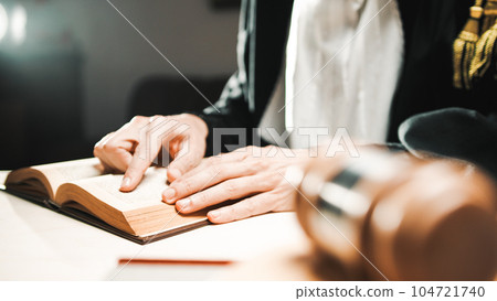 Judge reads the sentence to be afflicted on the criminal in the courtroom Judge reads the sentence to be afflicted on the criminal in the courtroom 104721740
